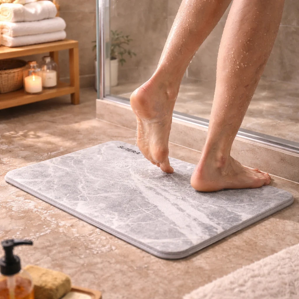 Feet on dry stone bath mat