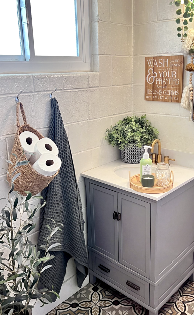 decorative bathroom with silverthread towel hung on a towel hook.