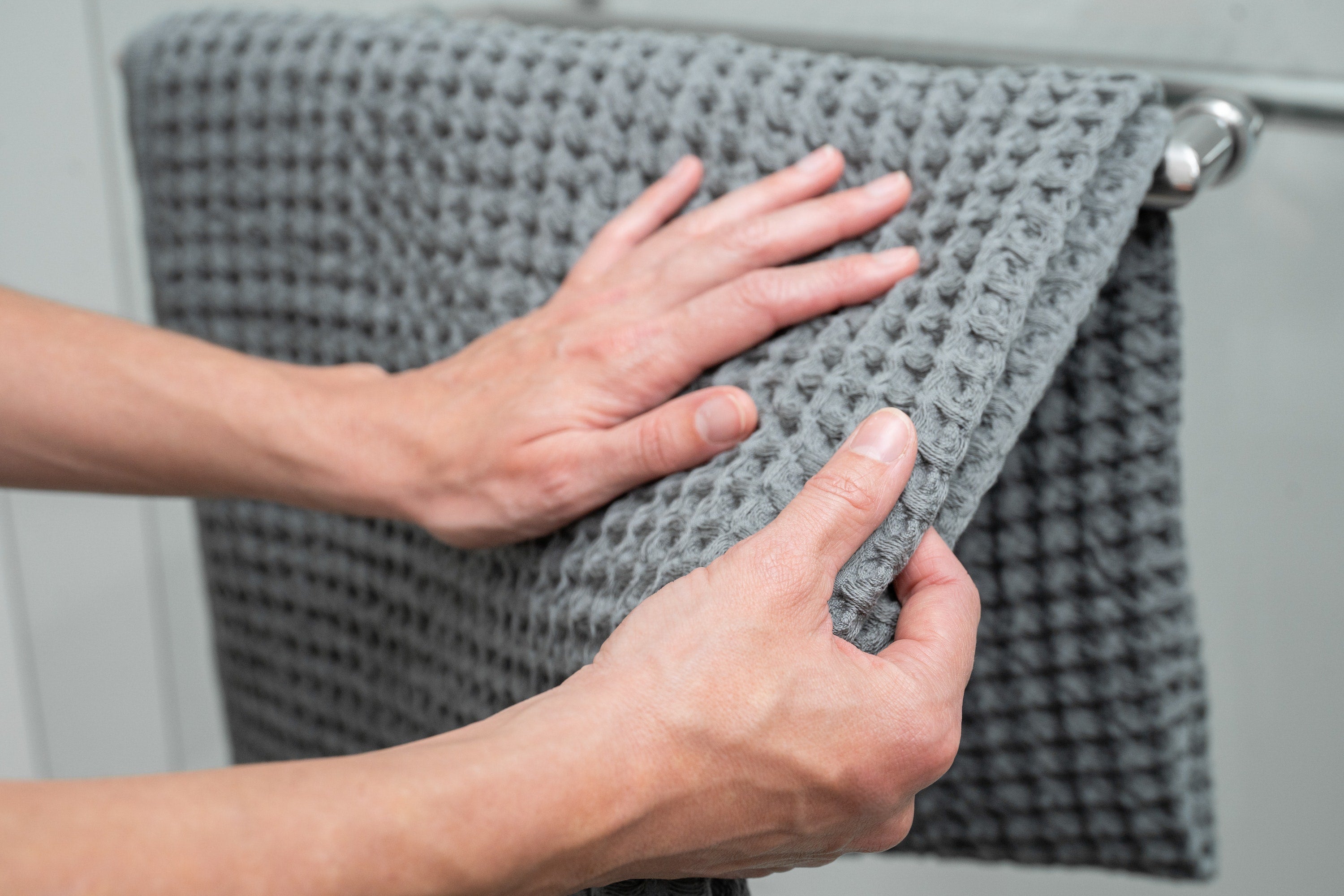 Hands caressing a silverthread towel