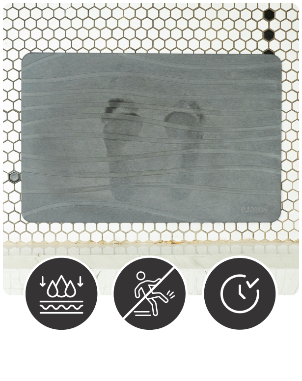 Stone Bath Mat with wet footprints showcasing: Diatomaceous Earth dries quickly, Textured design prevents slips, and Stone material lasts longer.